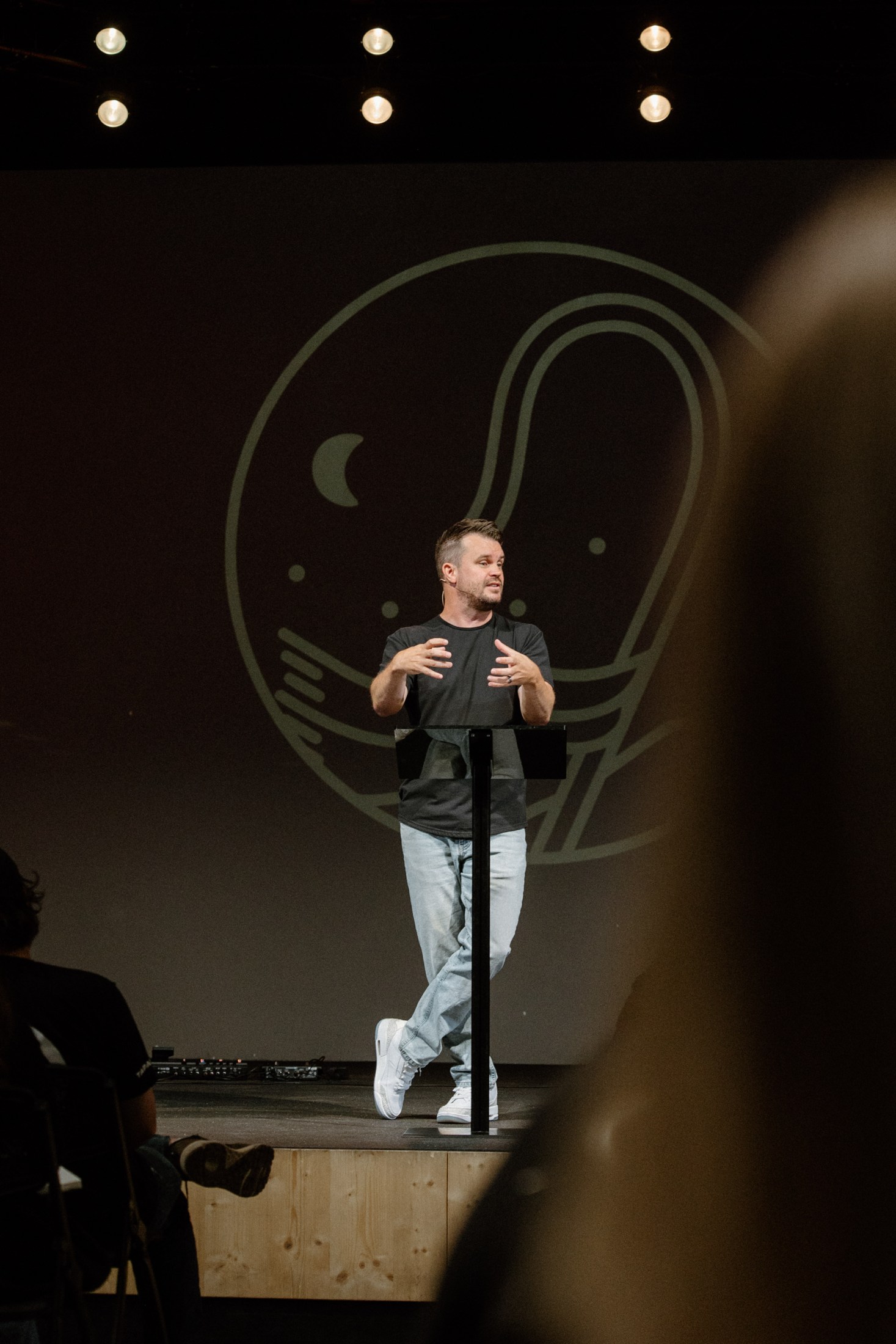 A pastor teaching from the stage at Rise