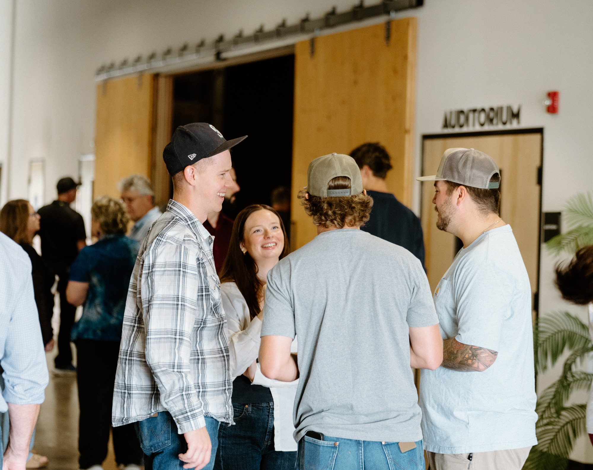 People sharing a conversation in the Rise lobby
