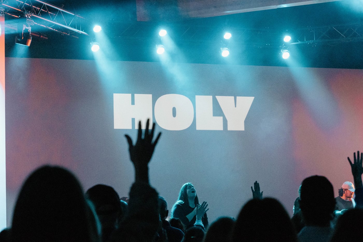 Hands raised during worship at Rise