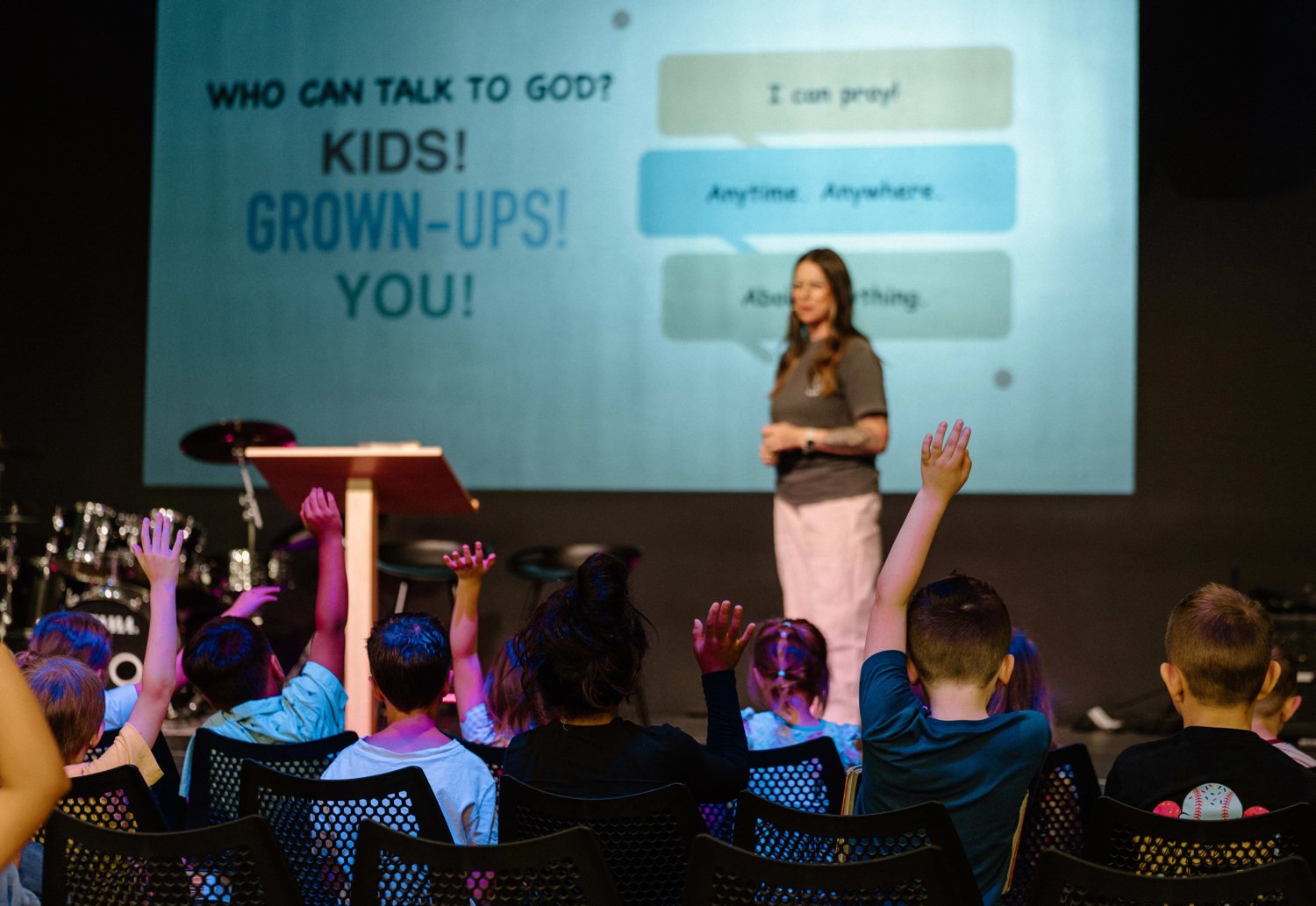 Kids raising their hands during teaching at Rise Kids