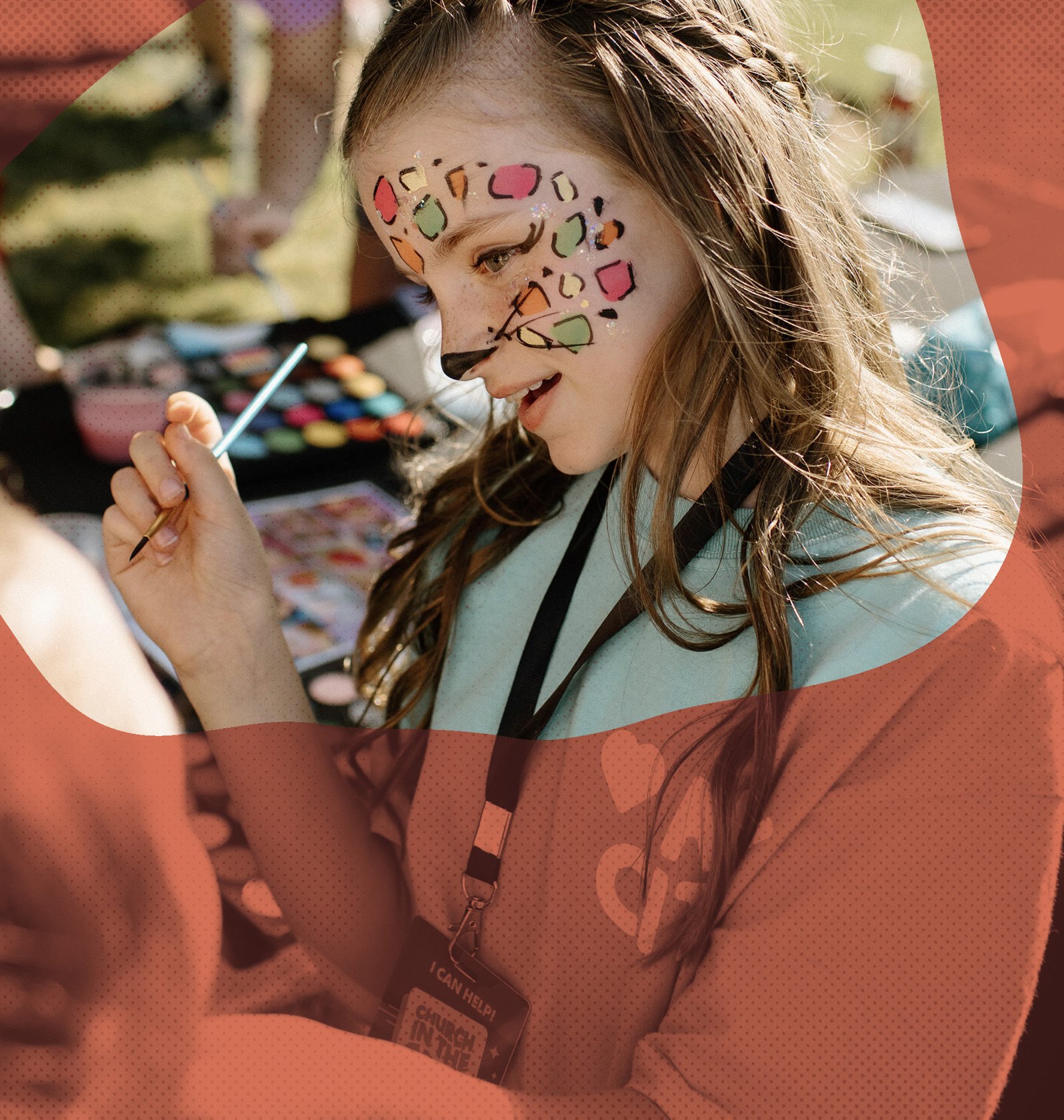 A child having their face painted at a community event